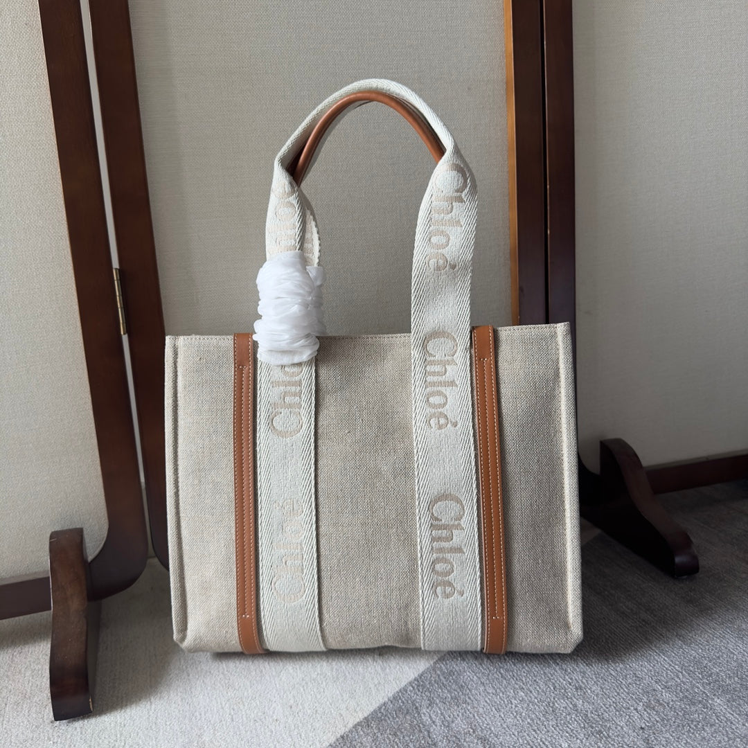 MEDIUM WOODY TOTE BAG 37 IN BEIGE LINEN CANVAS WEBBING LOGO EMBROIDERY BROWN CALFSKIN